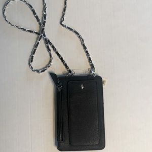 Cell phone crossbody purse, faux leather black with silver chain and hardware.